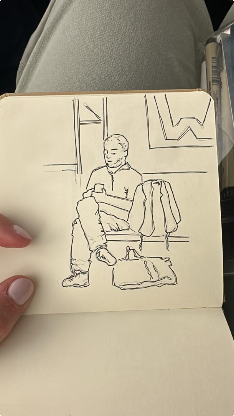 Ink drawing of a person sitting in a chair