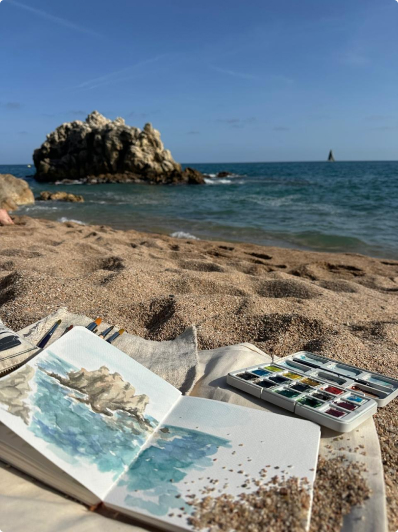 Watercolor of a rocky coast, painted on the beach
