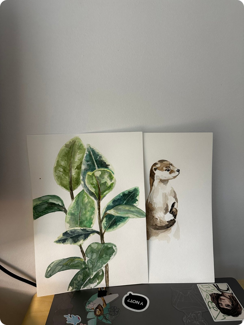 Watercolor of a leafy plant and an otter
